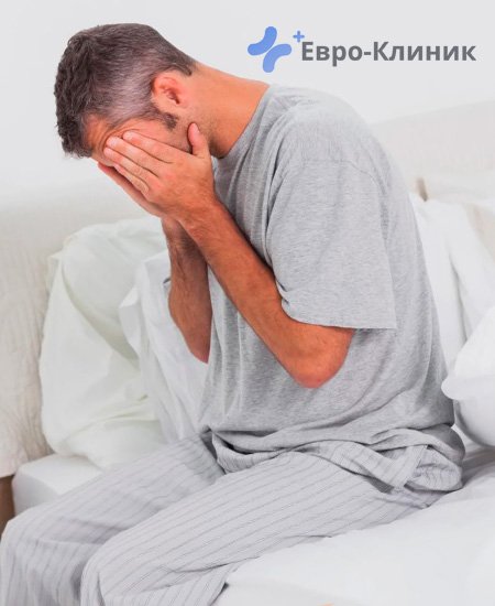 мужчина сидит на кровати, закрыв лицо руками мужчина с плохим самочувствием